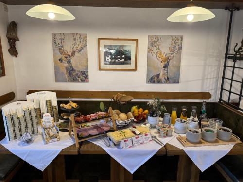 a table with a buffet of food on it at Pension Sonneck in Pfarrwerfen