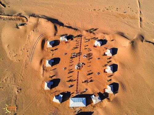 an aerial view of a desert with houses in the sand at Asafar Luxury Camp in Merdani