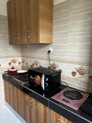 a kitchen with a microwave on a counter at Creative Palace in Nārāyanganj