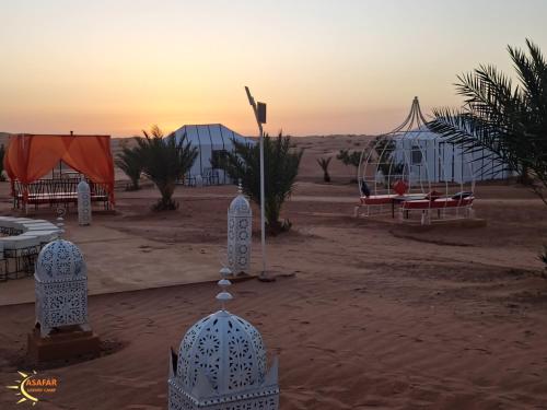 a view of a desert with tents and a swing at Asafar Luxury Camp in Merdani