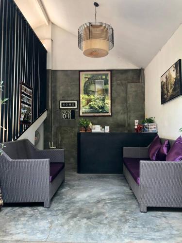 a living room with two couches and a table at Home Inn in Siem Reap
