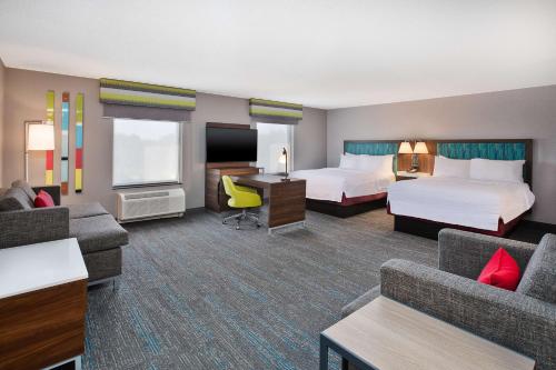 a hotel room with two beds and a desk at Hampton Inn Detroit - Shelby Township in Shelby