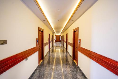 an empty corridor of a building with a hallway at Hotel Yathin in Mysore