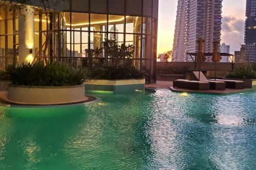 a pool in a building with green lighting at Luxury 32nd Floor 2 Bed-2 Bath Apartment with Pool, Harbour & Lotus Tower views in Colombo