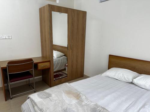 a bedroom with a bed and a desk and a mirror at Creative Palace in Nārāyanganj