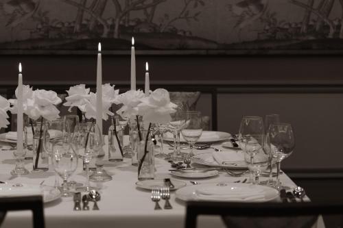 a table with wine glasses and candles on it at InterContinental New York Barclay Hotel by IHG in New York