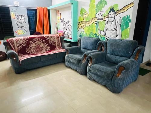 a living room with two chairs and a couch at Happy Home Varkala in Varkala