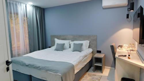 a bedroom with a large bed with blue walls at Эдельвейс Express in Almaty