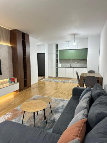 a living room with a couch and a table at Skyline Apartment 1 in Peje