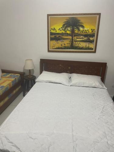 una camera da letto con un letto e un quadro sul muro di Casa Juquehy a São Sebastião