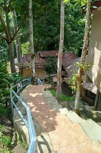 a walkway leading to a house with a blue railing at The Cascade - Mae Taeng Waterfall Bungalows in Ban Mae Ta Man (1)