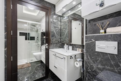a bathroom with a white sink and a toilet at Luxury Copacabana in Costa de Adeje
