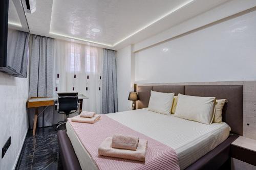 a bedroom with a bed with a desk and a computer at Luxury Copacabana in Costa de Adeje