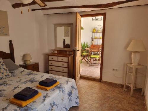 a bedroom with a bed with two towels on it at Casa Arriba Village House in Zarra in Zarra