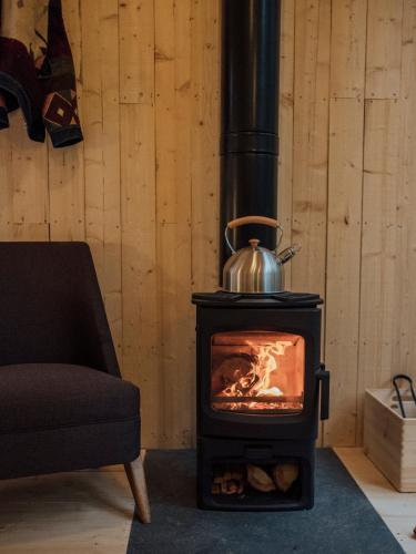 a stove with a tea kettle on top of it at Youza ecolodge in La Couture-Boussey