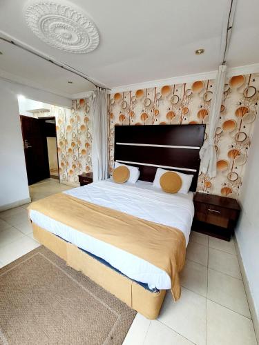 Postel nebo postele na pokoji v ubytování Nairobi Glory Palace Hotel