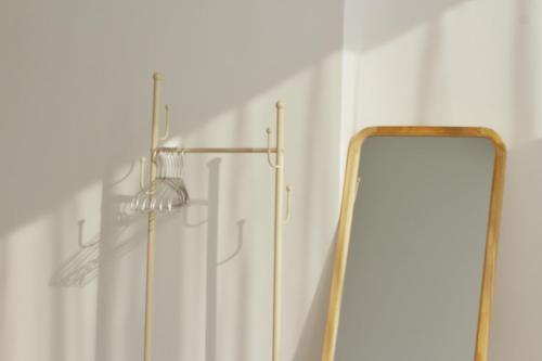 a mirror in a bathroom next to a shower at 大理十二花园民宿 in Dali