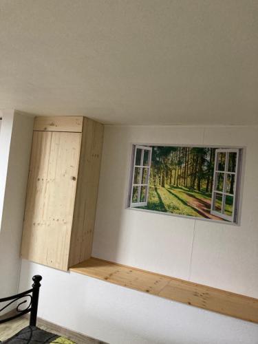 a room with two windows and a painting on the wall at HeiSa in Bitzen