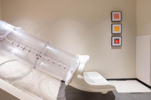 a white bathroom with a toilet in a room at Rest Collection RedHouse Melaka in Melaka