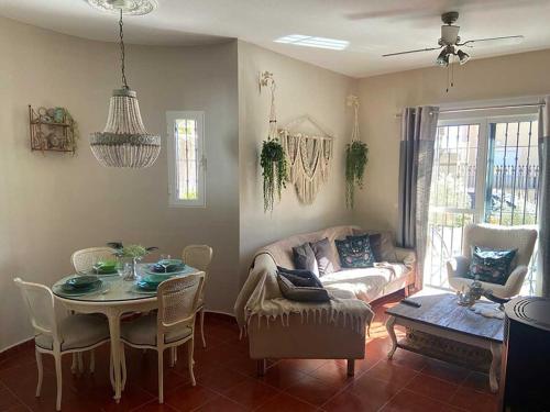 a living room with a couch and a table at Villa Marysol in Mazarrón