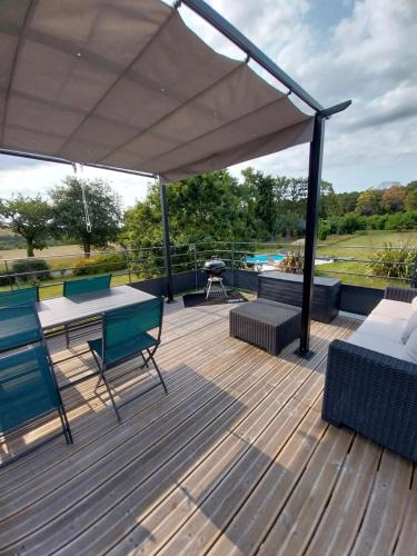 - une terrasse avec une table de pique-nique et un grill dans l'établissement Appartement à la campagne, à Noyal-Muzillac