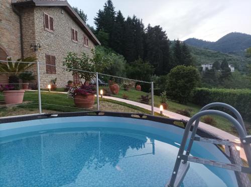 a swimming pool in front of a house at Villa Camelia Tuscany in Pescia