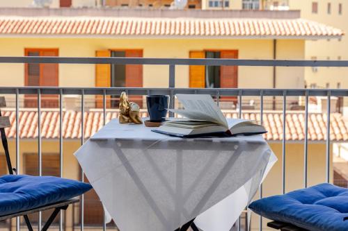 a table with a book and a cup and a drink at City Love Rooms in Siracusa
