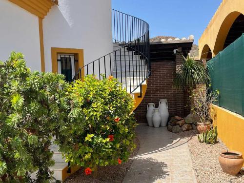 a house with some plants and a staircase at Villa Marysol in Mazarrón