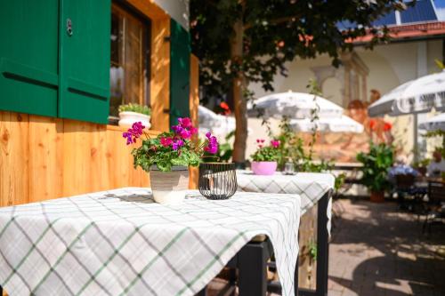 a table with a white table cloth with flowers on it at Hotel Restaurant Frühlingsgarten in Füssen