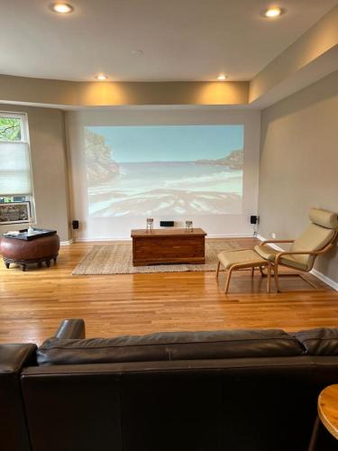 a living room with a large painting on the wall at Gorgeous North Kenwood Hyde Park Unit in Chicago