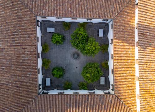 an aerial view of a courtyard with trees in a building at La Almoraima Hotel in Castellar de la Frontera