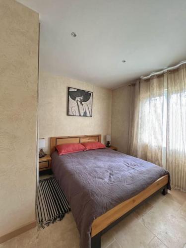 a bedroom with a large bed and a window at Maison de campagne profitez vue exceptionnelle in Bessins