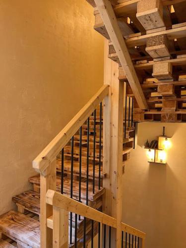 a staircase in a house with wooden ceilings at Maison de campagne profitez vue exceptionnelle in Bessins