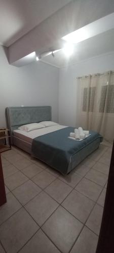 a bedroom with a bed in the middle of a room at La casa bella di Chalkida in Chalkida