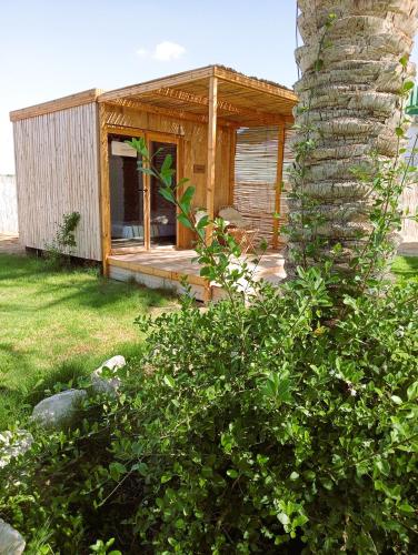 a small wooden house in a yard at Garden12 Outdoor & More in Douz