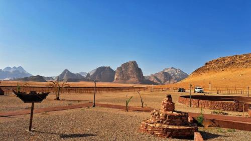 a view of a desert with mountains in the background at Dream Bedouin Life Camp Wadi Rum in Disah