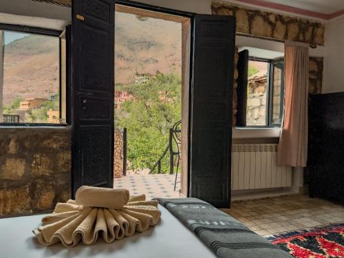 a room with a bed with a view of a mountain at Tonaroz House in Imlil