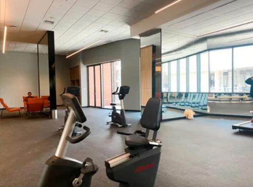 a gym with treadmills and exercise equipment in a building at Menara Jakarta Condo JI Expo PRJ by Blezz in Jakarta