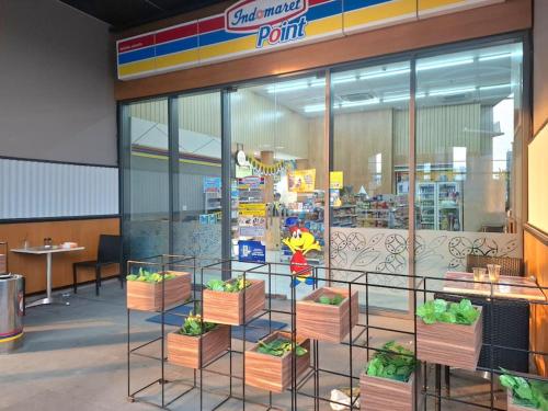 a store front with plants in boxes in a store at Menara Jakarta Condo JI Expo PRJ by Blezz in Jakarta