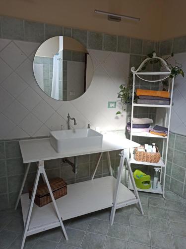 a bathroom with a white sink and a mirror at Appartamento Vale in Viareggio