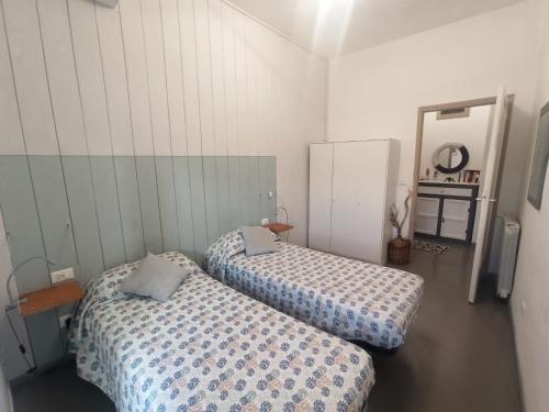 a room with two beds and a mirror at Appartamento Vale in Viareggio