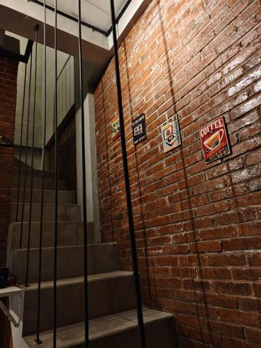 a brick wall with signs on the side of a building at Villa Pondok Kelapa Batu in Batu