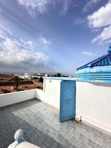 a blue door on the roof of a building at Villa Amara in Ouled Yaneg