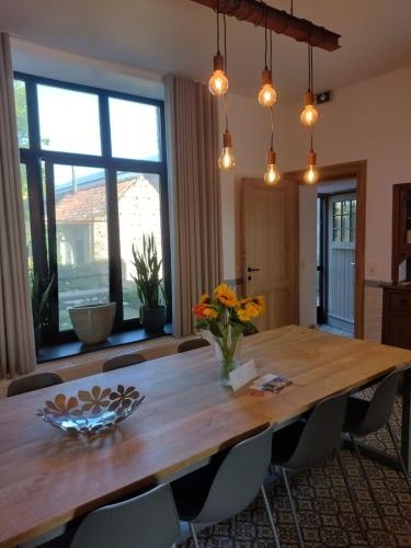a dining room with a wooden table and chairs at Huyze Vinck in Veurne