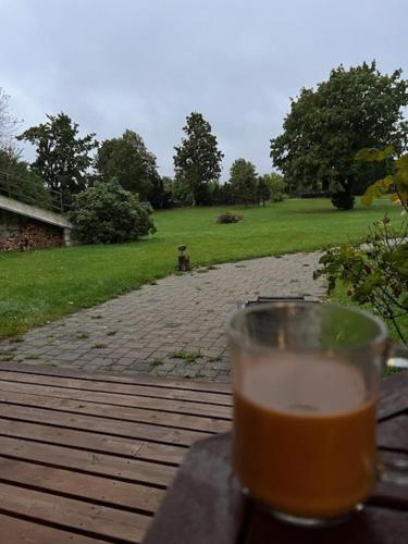 a glass of beer sitting on a table at Kangru Holiday Home in Vanamõisa