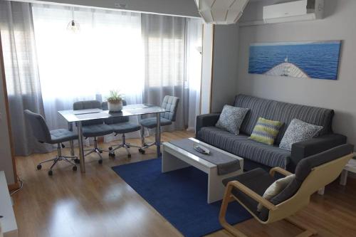 a living room with a couch and a table at Palomar Móstoles SuperHost con Garaje 5 Pax in Móstoles