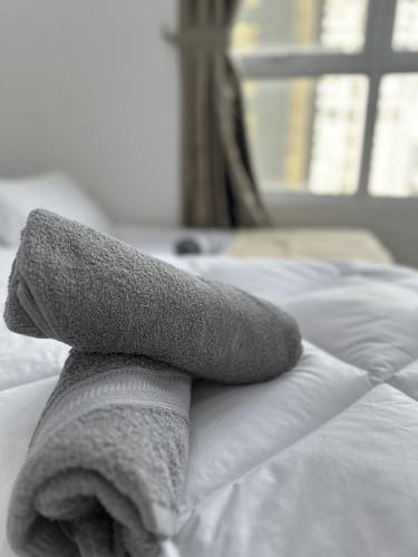 a towel is sitting on top of a bed at 10pax 3-Bedroom l Seaview l Georgetown l Gleneagles l Mansion One in George Town
