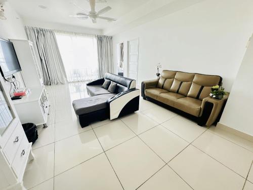 a living room with a couch and a tv at 10pax 3-Bedroom l Seaview l Georgetown l Gleneagles l Mansion One in George Town