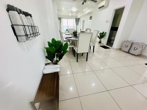 a dining room with a table and white tiled floor at 10pax 3-Bedroom l Seaview l Georgetown l Gleneagles l Mansion One in George Town