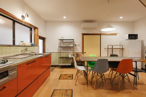a kitchen with a table and chairs in it at 海の陽 in Nonami